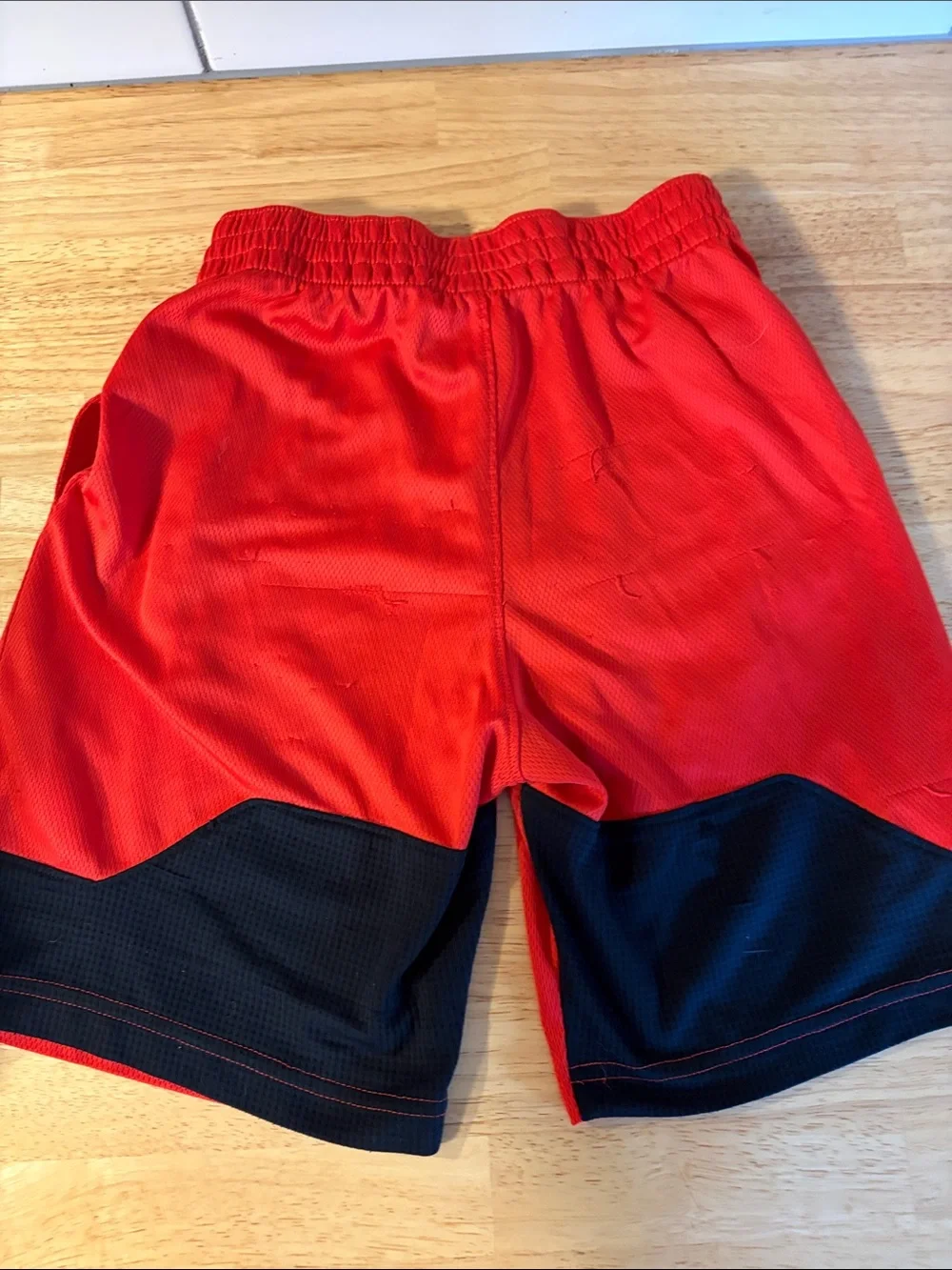 Nike Red Mesh Sports Shorts with Black Swoosh